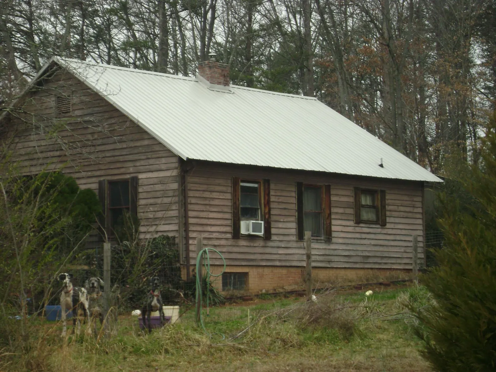White metal roof on an old wood sided farmhouse, from a Metal Roof Installation job in Blandon